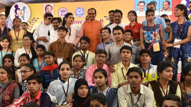 Meritorious students pose for a group picture with Madhya Pradesh chief minister Shivraj Singh Chouhan in Bhopal. (Mujeeb Faruqui/Hindustan Times) Meritorious students pose for a group picture with Madhya Pradesh chief minister Shivraj Singh Chouhan in Bhopal. (Mujeeb Faruqui/Hindustan Times)
