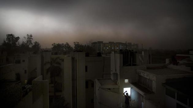 A man stands on the balcony of his apartment during a sudden storm accompanied by rain in New Delhi on May 13, 2018. At least 57 people were killed and many injured as severe storms accompanied by heavy rain, lightning and gusty winds swept through large swathes of the country on Sunday. (Manish Swarup / AP) A man stands on the balcony of his apartment during a sudden storm accompanied by rain in New Delhi on May 13, 2018. At least 57 people were killed and many injured as severe storms accompanied by heavy rain, lightning and gusty winds swept through large swathes of the country on Sunday. (Manish Swarup / AP)