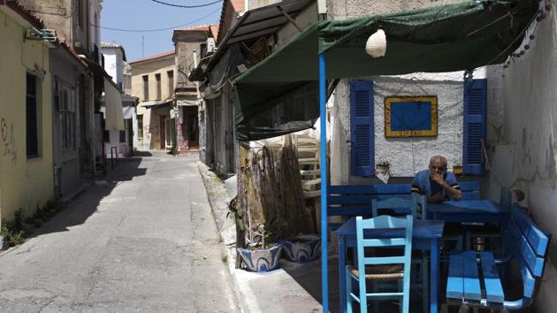 Many are angry to be missing out on a tourism boom that’s helping the country emerge from a decade of financial crisis. “We all welcomed the refugees. But there is a problem and it has to be taken seriously ... We have a good quality of life here and it’s been taken away,” said Akis Argiropoulos, a hotel manager. (Petros Giannakouris / AP) 