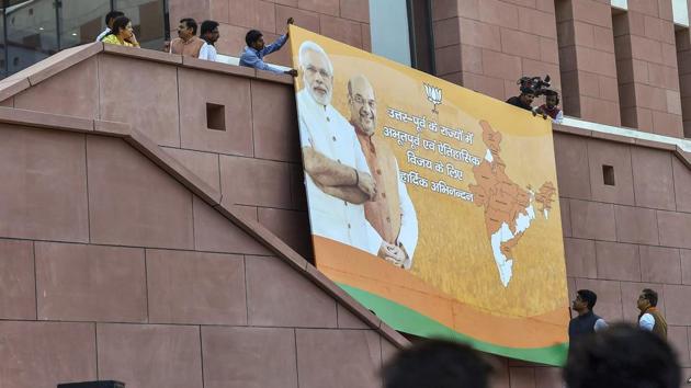 BJP party workers set up a poster of Prime Minister Narendra Modi and BJP president Amit Shah at party headquarters in New Delhi.(PTI File Photo) BJP party workers set up a poster of Prime Minister Narendra Modi and BJP president Amit Shah at party headquarters in New Delhi.(PTI File Photo)