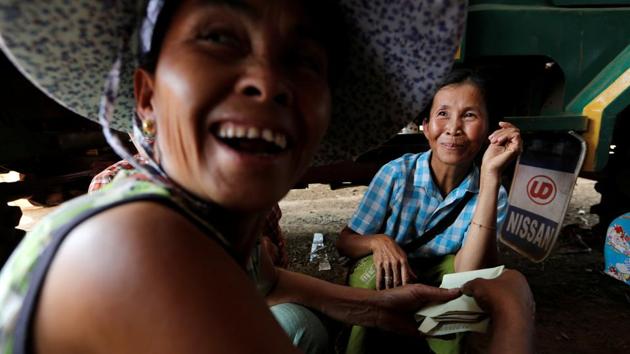 Shan women react after being paid for selling silkworm cocoons from their first harvest of the year, in Wanpaolong. Some villagers have moved to lower lying areas to take part. Others are now farming silkworms alongside other crops like watermelons. (Ann Wang / REUTERS) Shan women react after being paid for selling silkworm cocoons from their first harvest of the year, in Wanpaolong. Some villagers have moved to lower lying areas to take part. Others are now farming silkworms alongside other crops like watermelons. (Ann Wang / REUTERS)