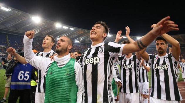 Juventus' Paulo Dybala, Stefano Sturaro and teammates celebrate after winning the Serie A title.(REUTERS)