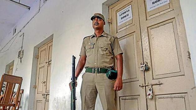 A security guard stands in front of a strong room after the panchayat poll at Nadia district in West Bengal on Tuesday.(PTI Photo)