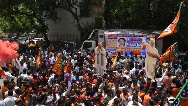 Supporters of ruling BJP celebrate as they carry cut-outs of their party’s president Amit Shah and Prime Minister Narendra Modi after learning of the initial poll results of Karnataka state assembly elections, in Bengaluru on May 15, 2018. (Arijit Sen / HT Photo) Supporters of ruling BJP celebrate as they carry cut-outs of their party’s president Amit Shah and Prime Minister Narendra Modi after learning of the initial poll results of Karnataka state assembly elections, in Bengaluru on May 15, 2018. (Arijit Sen / HT Photo)