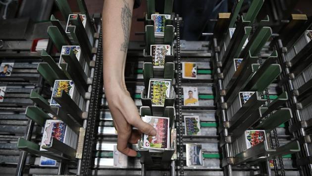 Since last January the machines which have remained unchanged since the 1960s, cut, mix and package at a faster rate than normal with the number of factory employees having jumped from 130 to 240 to keep pace with demand. Panini sees production peaks every two years with the European championships and the World Cup. (Marco Bertorello / AFP) Since last January the machines which have remained unchanged since the 1960s, cut, mix and package at a faster rate than normal with the number of factory employees having jumped from 130 to 240 to keep pace with demand. Panini sees production peaks every two years with the European championships and the World Cup. (Marco Bertorello / AFP)