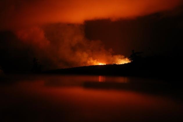 The latest Kilauea volcano activity illuminates the sky and is reflected off a vehicle (Bottom) on Hawaii's Big Island on May 14, 2018 in Pahoa, Hawaii. The US Geological Survey said a recent lowering of the lava lake at the volcano's Halemaumau crater "has raised the potential for explosive eruptions" at the volcano.(AFP) The latest Kilauea volcano activity illuminates the sky and is reflected off a vehicle (Bottom) on Hawaii's Big Island on May 14, 2018 in Pahoa, Hawaii. The US Geological Survey said a recent lowering of the lava lake at the volcano's Halemaumau crater "has raised the potential for explosive eruptions" at the volcano.(AFP)