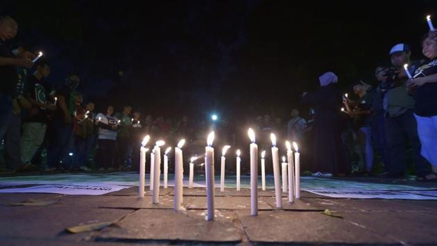 Lit candles are placed in the ground during a candlelight vigil in support of the victims and their relatives following a series of bomb attacks in Surabaya, in Jakarta on May 14, 2018.(AFP Photo) Lit candles are placed in the ground during a candlelight vigil in support of the victims and their relatives following a series of bomb attacks in Surabaya, in Jakarta on May 14, 2018.(AFP Photo)