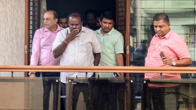 Janata Dal (Secular) president HD Kumaraswamy (centre) waves to his supporters after the Karnataka assembly election results, in Bengaluru, on Tuesday.(PTI)