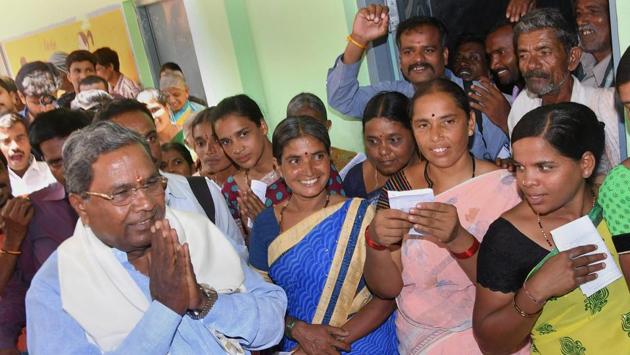 Karnataka chief minister Siddaramaiah (L) greets his supporters after voting in the Karnataka Assembly elections 2018, at Hundi village in Mysore on Saturday. In Chamundeshwari, Siddaramaiah lost to Deve Gowda of the JD(S) by over 35,000 votes. Meanwhile in Badami, he defeated his nearest BJP rival B Sreeramulu by over 4,000 votes. (PTI File)