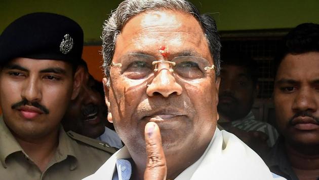 CM Siddaramaiah shows his inked finger after voting in the Karnataka assembly elections 2018, at Hundi village in Mysore. Counting of votes in Karnataka is underway on Tuesday.(PTI) CM Siddaramaiah shows his inked finger after voting in the Karnataka assembly elections 2018, at Hundi village in Mysore. Counting of votes in Karnataka is underway on Tuesday.(PTI)