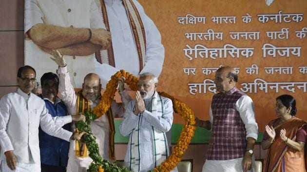 Bharatiya Janata Party president Amit Shah along with other party leaders congratulates Prime Minister Narendra Modi at the party headquarters after Karnataka election results, in New Delhi, on Tuesday. (Vipin Kumar/HT Photo) Bharatiya Janata Party president Amit Shah along with other party leaders congratulates Prime Minister Narendra Modi at the party headquarters after Karnataka election results, in New Delhi, on Tuesday. (Vipin Kumar/HT Photo)