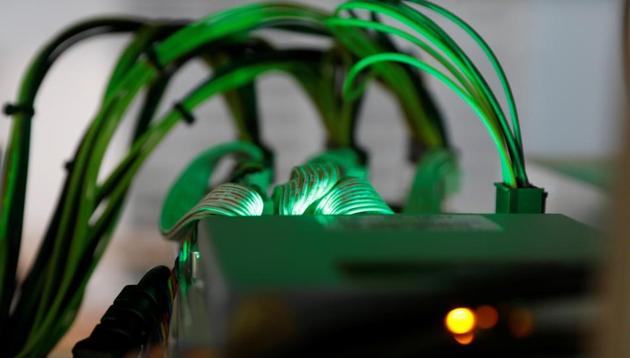 Cables running into cryptocurrency miners are seen at the HydroMiner cryptocurrency farming operation in Austria April 25, 2018.(Reuters File Photo) Cables running into cryptocurrency miners are seen at the HydroMiner cryptocurrency farming operation in Austria April 25, 2018.(Reuters File Photo)