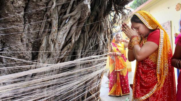 Women perform rituals near a Banyan tree during the ‘Vat Savitri Puja’ in Bhopal on Tuesday. On the occasion of this puja women observe a day-long fast and worship the Banyan tree for the longevity of their husbands. (PTI) Women perform rituals near a Banyan tree during the ‘Vat Savitri Puja’ in Bhopal on Tuesday. On the occasion of this puja women observe a day-long fast and worship the Banyan tree for the longevity of their husbands. (PTI)