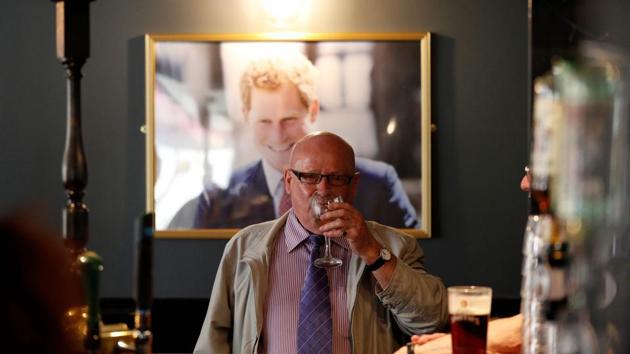 A portrait of Britain's Prince Harry hangs on the wall as drinkers sit at a bar inside a pub called 'The Prince Harry' near Windsor Castle in Windsor, west of London on May 15, 2018, as preparations get underway for the forthcoming Royal wedding. Britain's Prince Harry and US actress Meghan Markle will marry on May 19 at St George's Chapel in Windsor Castle. (AFP) A portrait of Britain's Prince Harry hangs on the wall as drinkers sit at a bar inside a pub called 'The Prince Harry' near Windsor Castle in Windsor, west of London on May 15, 2018, as preparations get underway for the forthcoming Royal wedding. Britain's Prince Harry and US actress Meghan Markle will marry on May 19 at St George's Chapel in Windsor Castle. (AFP)