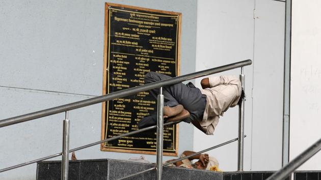 For many in the city, coming back home after work to the bed is the best feeling ever. But not everyone is that fortunate. This man, tired of the heat and work, is busy sleeping on the steel rod of a hand railing. A scene from Mitra Mandal chowk near Sarasbaug on Sunday. (Rahul Raut/HT PHOTO) For many in the city, coming back home after work to the bed is the best feeling ever. But not everyone is that fortunate. This man, tired of the heat and work, is busy sleeping on the steel rod of a hand railing. A scene from Mitra Mandal chowk near Sarasbaug on Sunday. (Rahul Raut/HT PHOTO)