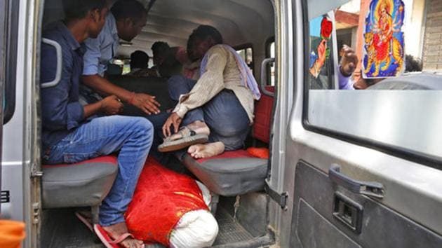 People prepare to leave a hospital with the body of Shiv, 37, who along with his father and two brothers got killed after a highway overpass being built collapsed Tuesday in Varanasi. (AP) People prepare to leave a hospital with the body of Shiv, 37, who along with his father and two brothers got killed after a highway overpass being built collapsed Tuesday in Varanasi. (AP)