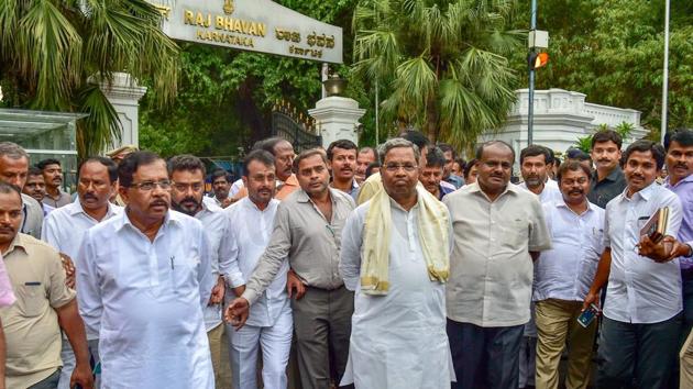Outgoing Karnataka chief minister Siddaramaiah, JD(S) president H D Kumaraswamy with other leaders leave after meeting with Governor Rudabhai Vajubhai Vala as Congress extends party support to JD(S) to form the new government after Karnataka Assembly Election results 2018 in Bengaluru on Tuesday. (PTI Photo) Outgoing Karnataka chief minister Siddaramaiah, JD(S) president H D Kumaraswamy with other leaders leave after meeting with Governor Rudabhai Vajubhai Vala as Congress extends party support to JD(S) to form the new government after Karnataka Assembly Election results 2018 in Bengaluru on Tuesday. (PTI Photo)