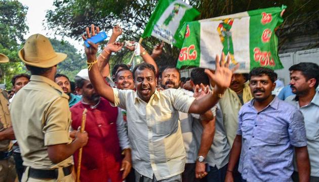 After the Karnataka election results, JD(S) workers celebrate outside the Raj Bhavan after the Congress extended support to it for government formation, in Bengaluru, on Tuesday. (PTI) After the Karnataka election results, JD(S) workers celebrate outside the Raj Bhavan after the Congress extended support to it for government formation, in Bengaluru, on Tuesday. (PTI)