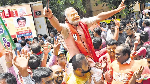 BJP supporters celebrate outside the party office after Karnataka poll results on Tuesday.(Arijit Sen/HT Photo)