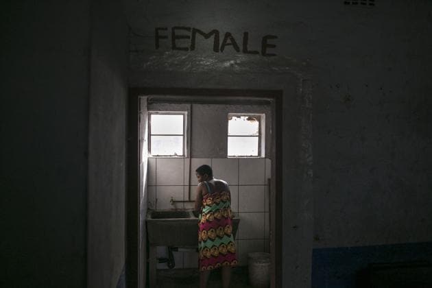 A woman washes clothing in the bathroom of an abandoned building occupied by mostly Malawian migrants. The state has the money and land and should provide housing at affordable prices, according to Stuart Wilson, the executive director of the Socio-Economic Rights Institute of South Africa, calling the city “not particularly keen” on public housing. (Bram Janssen / AP) A woman washes clothing in the bathroom of an abandoned building occupied by mostly Malawian migrants. The state has the money and land and should provide housing at affordable prices, according to Stuart Wilson, the executive director of the Socio-Economic Rights Institute of South Africa, calling the city “not particularly keen” on public housing. (Bram Janssen / AP)