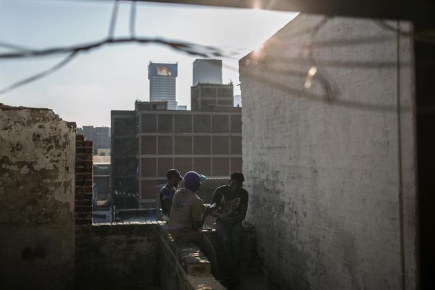 Malawian migrants sit on the rooftop of an abandoned building. Mayor Herman Mashaba has alarmed residents of South Africa’s largest city of more than 4.4 million people by accusing migrants from other countries for making up the majority of squatters, contributing to the xenophobia that periodically flares into violent attacks. Foreigners “are not the responsibility of the city,” he said last year. (Bram Janssen / AP) Malawian migrants sit on the rooftop of an abandoned building. Mayor Herman Mashaba has alarmed residents of South Africa’s largest city of more than 4.4 million people by accusing migrants from other countries for making up the majority of squatters, contributing to the xenophobia that periodically flares into violent attacks. Foreigners “are not the responsibility of the city,” he said last year. (Bram Janssen / AP)