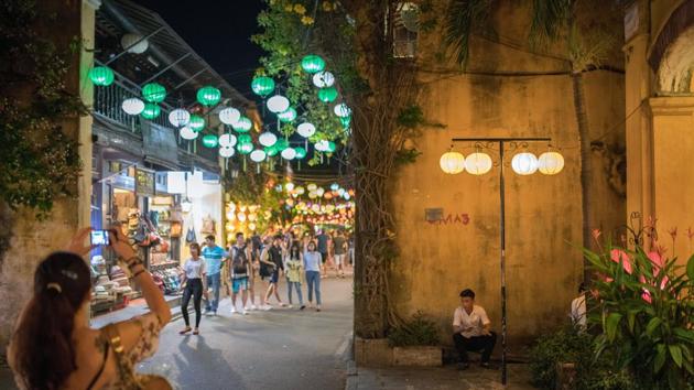 A man sits as tourists walk by in the old town of Hoi An, Qung Nam Province, Vietnam.(Bloomberg File Photo) A man sits as tourists walk by in the old town of Hoi An, Qung Nam Province, Vietnam.(Bloomberg File Photo)