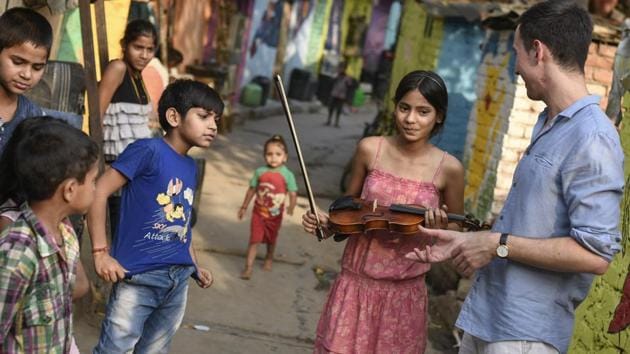 Tomasz Pajak and other students seen inside Sanjay Camp. Apart from cultivating a hobby with the instrument, the initiative also favours social integration by providing the children an early start with a skill that can also turn into a vocation once they’re grown up. (Burhaan Kinu / HT Photo)