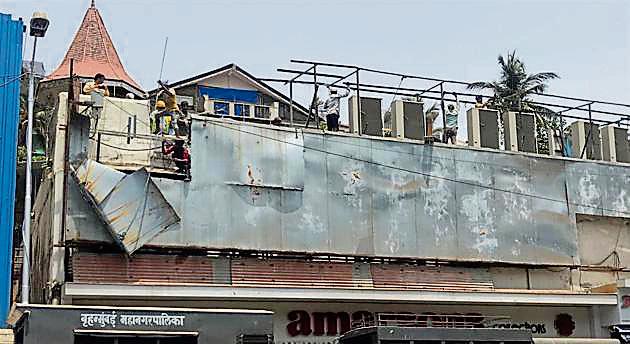 The store owners had built five unauthorised sheds on the terrace and put up a sign board without permission(HT photo)