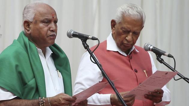 Karnataka state Governor Vajubhai Vala, right, administers oath to Bharatiya Janata Party (BJP) leader B. S. Yeddyurappa, left, as Chief Minister of the state in Bangalore, India, Thursday, May 17, 2018.(AP)