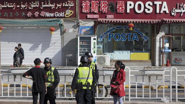 In this Nov. 3, 2017 photo, residents are seen with security personnel on the streets of Hotan in western China's Xinjiang region. China’s “strike hard” campaign in remote Xinjiang is set to intensify in the month of Ramzan with reports saying monitoring of minority Muslim communities in the province had become invasive.(AP Photo) In this Nov. 3, 2017 photo, residents are seen with security personnel on the streets of Hotan in western China's Xinjiang region. China’s “strike hard” campaign in remote Xinjiang is set to intensify in the month of Ramzan with reports saying monitoring of minority Muslim communities in the province had become invasive.(AP Photo)
