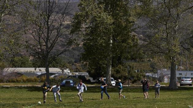 A group of students play outside the Howard School in Carpinteria located near a cannabis farm. The area’s greenhouses have their roots in Carpinteria’s cut flower industry, which was sapped after the US government granted trade preferences to South American countries in the 1990s to encourage their farmers to grow flowers instead of coca, the plant used to make cocaine. (Jae C. Hong / AP) A group of students play outside the Howard School in Carpinteria located near a cannabis farm. The area’s greenhouses have their roots in Carpinteria’s cut flower industry, which was sapped after the US government granted trade preferences to South American countries in the 1990s to encourage their farmers to grow flowers instead of coca, the plant used to make cocaine. (Jae C. Hong / AP)
