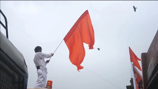 A file photo of a Shiv Sena member waving the party flag.(HT PHOTO)