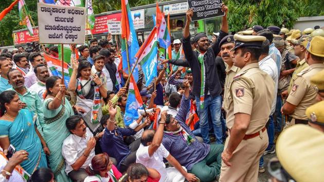 Police stops Congress party workers marching towards Raj Bhawan during a protest against the Karnataka Governor in Bengaluru. The protests were observed against Karnataka Governor Vajubhai Vala’s alleged ‘collusion with the BJP’ and his ‘partisan’ action of inviting BJP leader B.S. Yeddyurappa to take oath as chief minister following a split verdict in the state. (Shailendra Bhojak / PTI) Police stops Congress party workers marching towards Raj Bhawan during a protest against the Karnataka Governor in Bengaluru. The protests were observed against Karnataka Governor Vajubhai Vala’s alleged ‘collusion with the BJP’ and his ‘partisan’ action of inviting BJP leader B.S. Yeddyurappa to take oath as chief minister following a split verdict in the state. (Shailendra Bhojak / PTI)