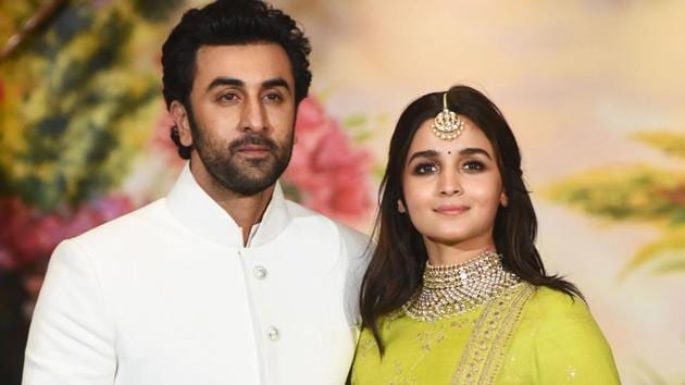 Indian Bollywood actors Ranbir Kapoor (L) and Alia Bhatt pose for a picture during the wedding reception of actor Sonam Kapoor and businessman Anand Ahuja in Mumbai.(AFP)