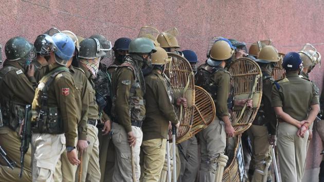 Police stand guard during clashes outside a college in Srinagar.(AFP File Photo)