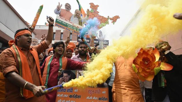Bharatiya Janata Party (BJP) activists and workers celebrate party's lead in Karnataka elections outside BJP headquarters, in New Delhi, on May 15, 2018. (Burhaan Kinu / HT Photo) Bharatiya Janata Party (BJP) activists and workers celebrate party's lead in Karnataka elections outside BJP headquarters, in New Delhi, on May 15, 2018. (Burhaan Kinu / HT Photo)