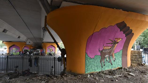The large murals of Hanuman, contextually tied to the area’s landmark temple, were completed earlier in April. Other motifs include life in medieval Delhi, and local flora and fauna, seen here decorating the pillars under the flyover. (Sanchit Khanna / HT Photo) The large murals of Hanuman, contextually tied to the area’s landmark temple, were completed earlier in April. Other motifs include life in medieval Delhi, and local flora and fauna, seen here decorating the pillars under the flyover. (Sanchit Khanna / HT Photo)