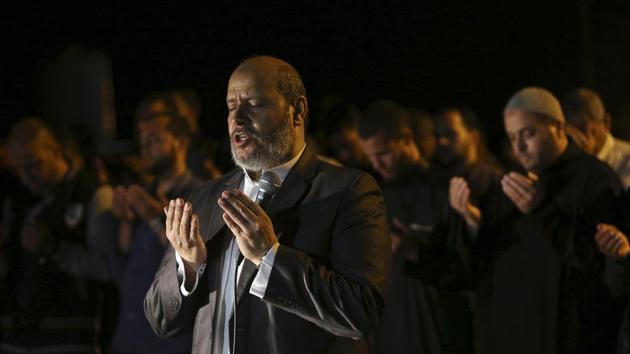 Another hallmark of Ramadan is nightly prayer at the mosque among Sunni Muslims called “tarawih.” Hamas leader Khalil al-Hayya is seen here leading the prayer outside the tents of the protest camp near the Israeli border east of Gaza City. (Adel Hana / AP) 