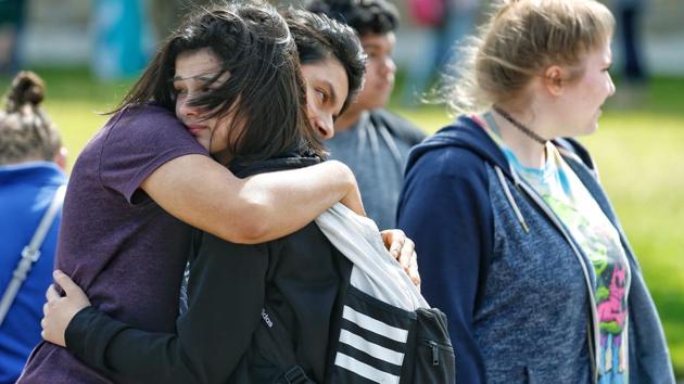 Santa Fe High School freshman Caitlyn Girouard, center, hugs her friend outside the Alamo Gym where students and parents wait to reunite following a shooting at Santa Fe High School Friday, May 18, 2018, in Santa Fe, Texas. (AP) Santa Fe High School freshman Caitlyn Girouard, center, hugs her friend outside the Alamo Gym where students and parents wait to reunite following a shooting at Santa Fe High School Friday, May 18, 2018, in Santa Fe, Texas. (AP)