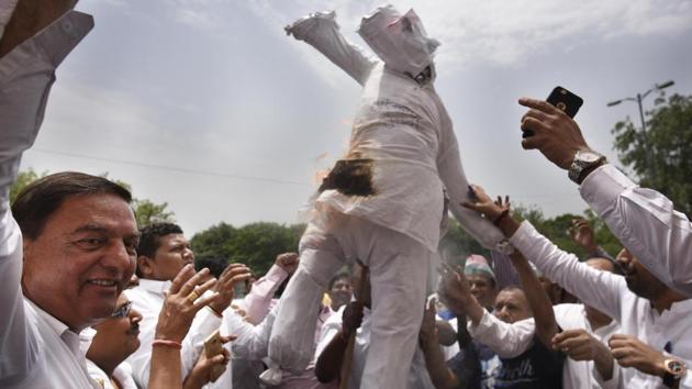 Congress supporters burn an effigy of Prime Minister Narendra Modi, as DPCC president Ajay Maken along with former Delhi chief minister Sheila Dikshit take part in a ‘Save Democracy Day’ protest in New Delhi. The BJP emerged as the largest party in Karnataka, getting 104 seats, followed by the Congress with 78, Janata Dal (Secular) with 37 in the 224-member Assembly where elections. (Vipin Kumar / HT Photo) Congress supporters burn an effigy of Prime Minister Narendra Modi, as DPCC president Ajay Maken along with former Delhi chief minister Sheila Dikshit take part in a ‘Save Democracy Day’ protest in New Delhi. The BJP emerged as the largest party in Karnataka, getting 104 seats, followed by the Congress with 78, Janata Dal (Secular) with 37 in the 224-member Assembly where elections. (Vipin Kumar / HT Photo)