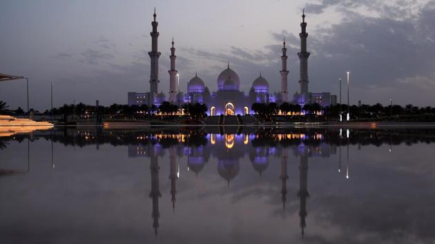 The Grand Mosque Sheikh Zayed is seen lit up in Abu Dhabi, United Arab Emirates. In the Arabian Gulf countries, families hold “majlises” where they open their doors for people to pass by at all hours of the night for food, tea, coffee and conversation. The intense nights of prayer will eventually be met with the three-day holiday of Eid al-Fitr. (Karim Sahib / AFP) 