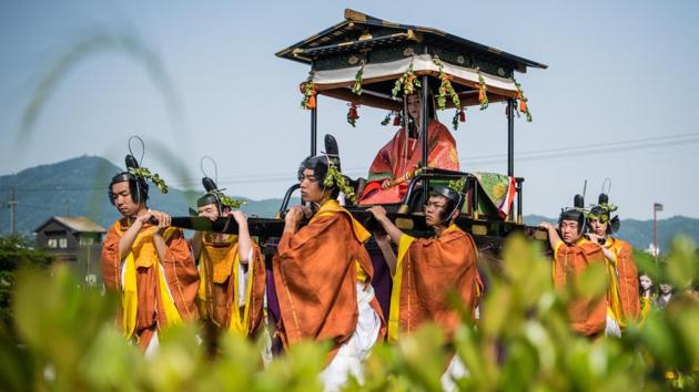 Saio-Dai, whose role is now played by an unmarried woman from Kyoto but was traditionally carried out by a sister or daughter of the Emperor to dedicate herself to the Shimogamo shrine, is carried on a palanquin during the Aoi Festival in Kyoto, Japan. (Carl Court / Getty Images) Saio-Dai, whose role is now played by an unmarried woman from Kyoto but was traditionally carried out by a sister or daughter of the Emperor to dedicate herself to the Shimogamo shrine, is carried on a palanquin during the Aoi Festival in Kyoto, Japan. (Carl Court / Getty Images)