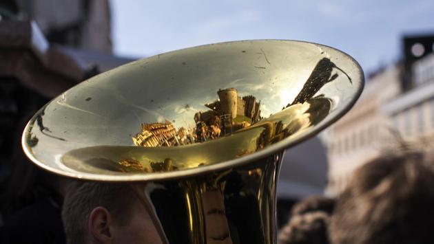 Windsor castle is seen reflected on the trombone of students musicians playing their instruments for the crowd, in England. (Emilio Morenatti / AP) Windsor castle is seen reflected on the trombone of students musicians playing their instruments for the crowd, in England. (Emilio Morenatti / AP)