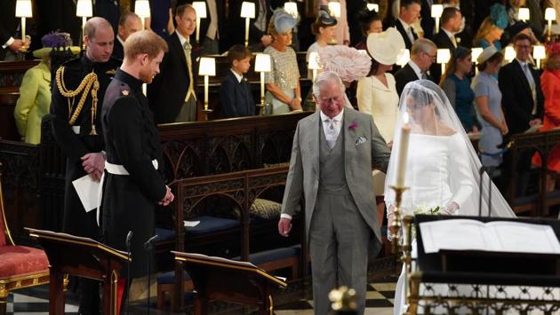 Prince Harry looks at his bride, Meghan Markle, as she arrives accompanied by Prince Charles. Markle is wearing Queen Mary’s diamond bandeau tiara. (Jonathan Brady / Pool via AP) Prince Harry looks at his bride, Meghan Markle, as she arrives accompanied by Prince Charles. Markle is wearing Queen Mary’s diamond bandeau tiara. (Jonathan Brady / Pool via AP)