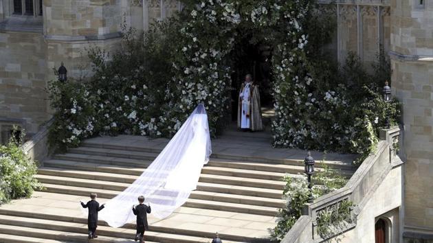 Meghan Markle arrives at St. George's Chapel in Windsor Castle. Her dress has been designed by Clare Waight Keller for French fashion house Givenchy. (Andrew Matthews / Pool via AP) Meghan Markle arrives at St. George's Chapel in Windsor Castle. Her dress has been designed by Clare Waight Keller for French fashion house Givenchy. (Andrew Matthews / Pool via AP)