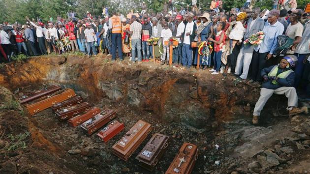 Coffins are seen arranged inside a mass grave during the burial of people killed when a dam burst its walls, overrunning nearby homes, in Solai town near Nakuru, Kenya. (Thomas Mukoya / REUTERS) Coffins are seen arranged inside a mass grave during the burial of people killed when a dam burst its walls, overrunning nearby homes, in Solai town near Nakuru, Kenya. (Thomas Mukoya / REUTERS)