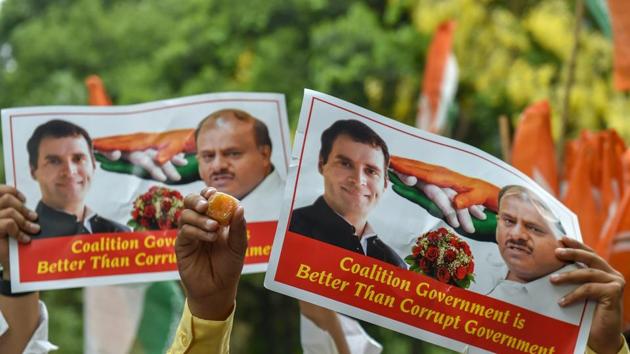 Congress supporters raise posters of party president Rahul Gandhi and JD(S) chief HD Kumarswamy after Karnataka chief minister BS Yeddyurappa announced his resignation, in New Delhi on May 19. (PTI Photo) Congress supporters raise posters of party president Rahul Gandhi and JD(S) chief HD Kumarswamy after Karnataka chief minister BS Yeddyurappa announced his resignation, in New Delhi on May 19. (PTI Photo)