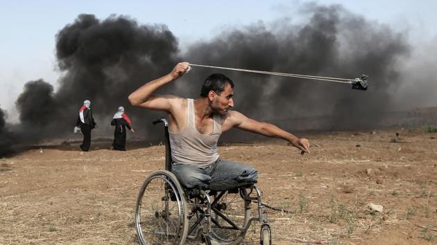 Palestinian Saber al-Ashkar, 29, hurls rocks during clashes with Israeli forces along the border with the Gaza strip, east of Gaza City. (Mahmud Hams / AFP) Palestinian Saber al-Ashkar, 29, hurls rocks during clashes with Israeli forces along the border with the Gaza strip, east of Gaza City. (Mahmud Hams / AFP)