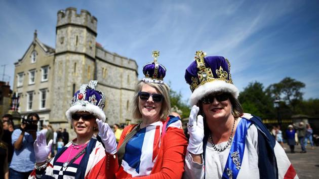 Three women wear crowns and flags near Windsor Castle a day before the wedding of Prince Harry and Meghan Markle. It’d be hard to find somebody in this small town who isn’t gripped by Royal fever! (Clodagh Kilcoyne / REUTERS)