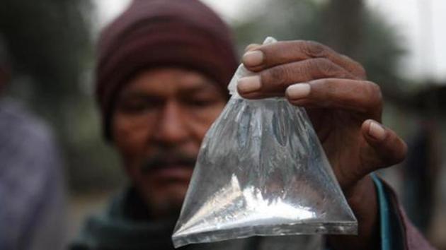 A villager of Enayatpur of Magrahat showing a packet of 'Hooch Pouch' at Magrahat in West Bengal, India.(HT File Photo)